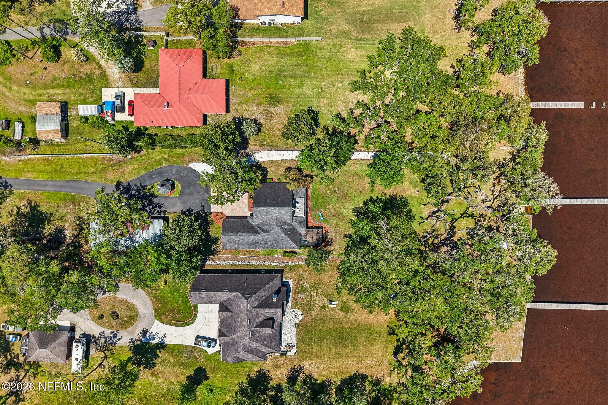 4745 Raggedy Point Road Fleming Island, FL 32003 - Photo 99 of 106 an aerial view of residential house with outdoor space and swimming pool