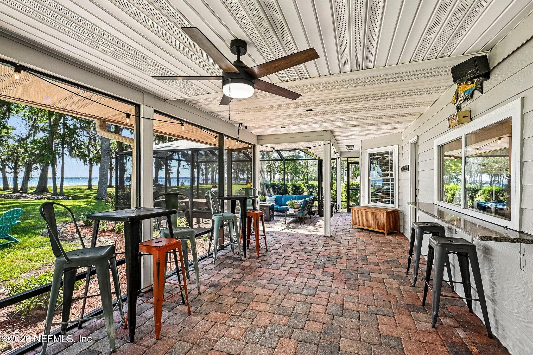 4745 Raggedy Point Road Fleming Island, FL 32003 - Photo 10 of 106 a outdoor space with lots of tables a large window and furniture