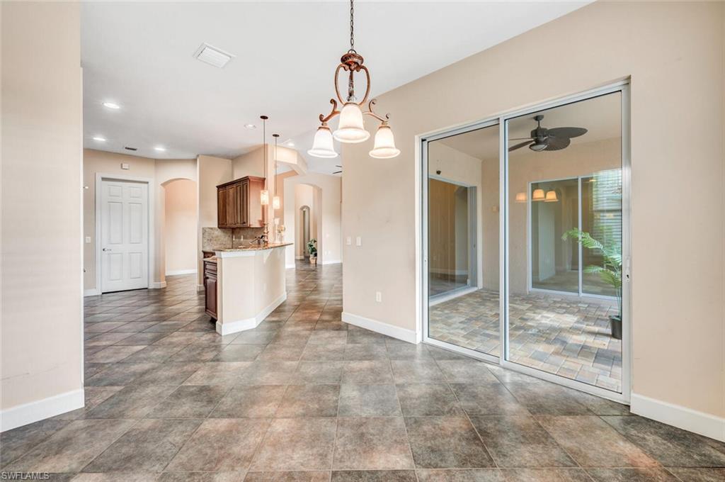 8237 Valiant Drive Naples, FL 34104 - Photo 11 of 35 Unfurnished dining area featuring tile patterned flooring and ceiling fan
