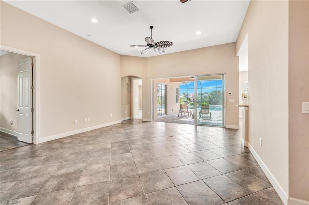 8237 Valiant Drive Naples, FL 34104 - Photo 15 of 35 Tiled empty room with ceiling fan
