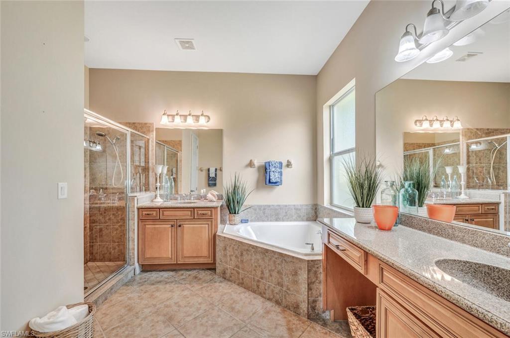 8237 Valiant Drive Naples, FL 34104 - Photo 20 of 35 Bathroom featuring tile patterned flooring, separate shower and tub, and vanity
