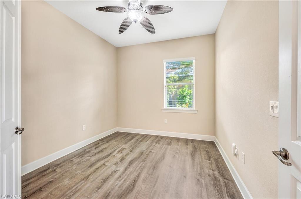 8237 Valiant Drive Naples, FL 34104 - Photo 24 of 35 Spare room featuring hardwood / wood-style floors and ceiling fan