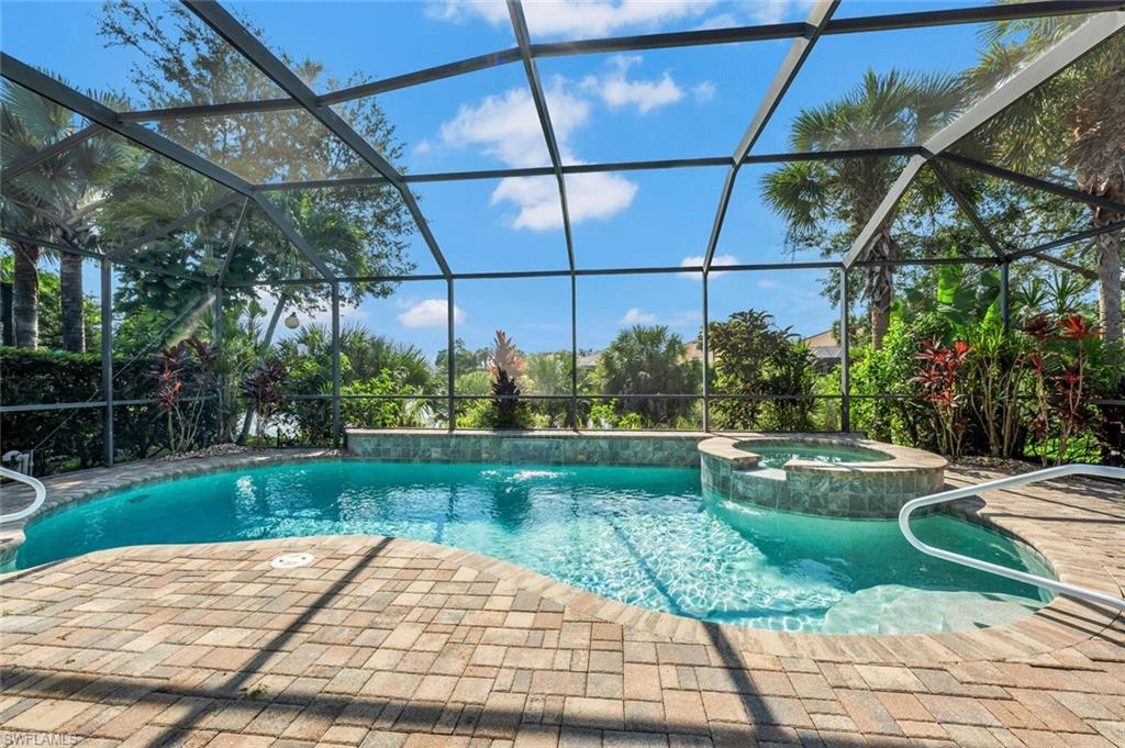 8237 Valiant Drive Naples, FL 34104 - Photo 30 of 35 View of pool featuring an in ground hot tub, a lanai, and a patio area