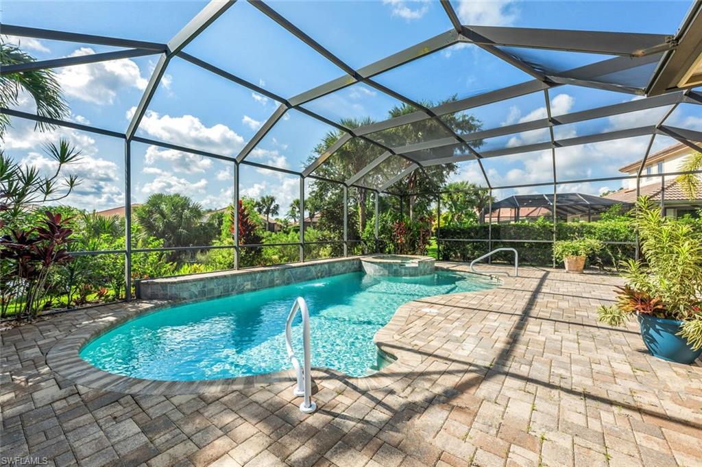 8237 Valiant Drive Naples, FL 34104 - Photo 31 of 35 View of swimming pool featuring an in ground hot tub, a patio, pool water feature, and a lanai