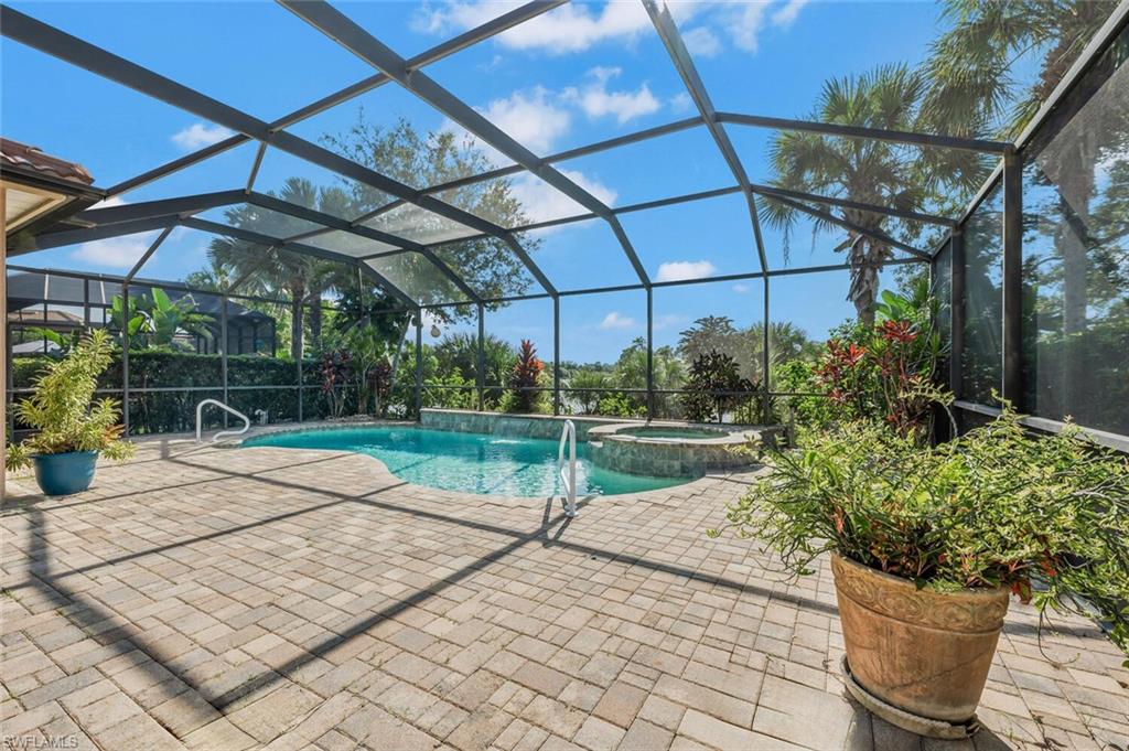 8237 Valiant Drive Naples, FL 34104 - Photo 32 of 35 View of pool featuring a patio, an in ground hot tub, pool water feature, and a lanai