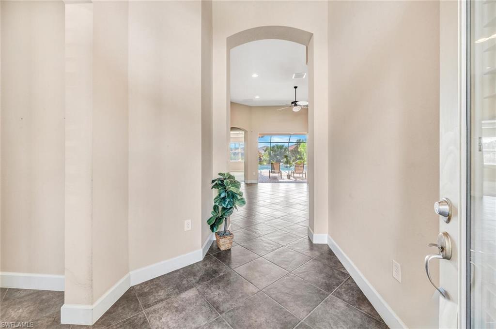 8237 Valiant Drive Naples, FL 34104 - Photo 4 of 35 Hall with tile patterned floors