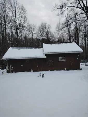 a front view of a house with trees