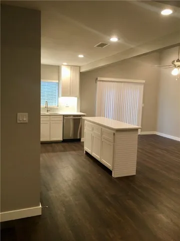 a room with wooden floors and white walls