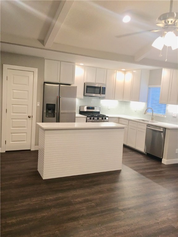 8307 Renton Drive Austin, TX 78757 - Photo 4 of 8 a large kitchen with stainless steel appliances a sink a counter top space cabinets and a window