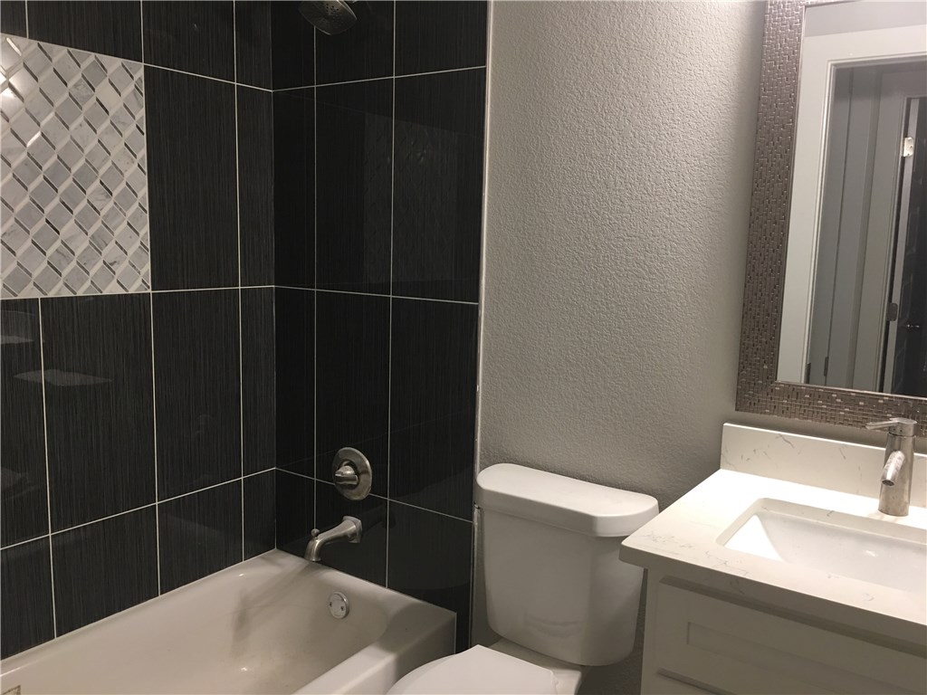 8307 Renton Drive Austin, TX 78757 - Photo 7 of 8 a bathroom with a sink toilet and shower