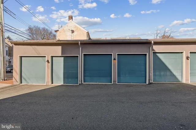 a view of a white house with a large space