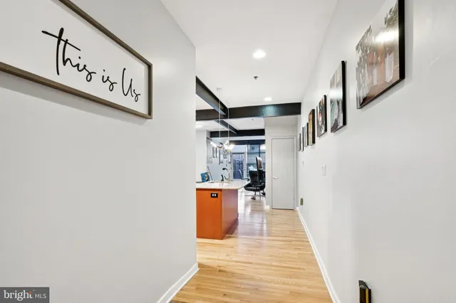 a view of a hallway with wooden floor and staircase