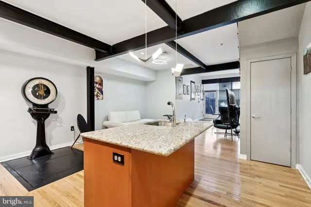a view of living room with granite countertop furniture and wooden floor