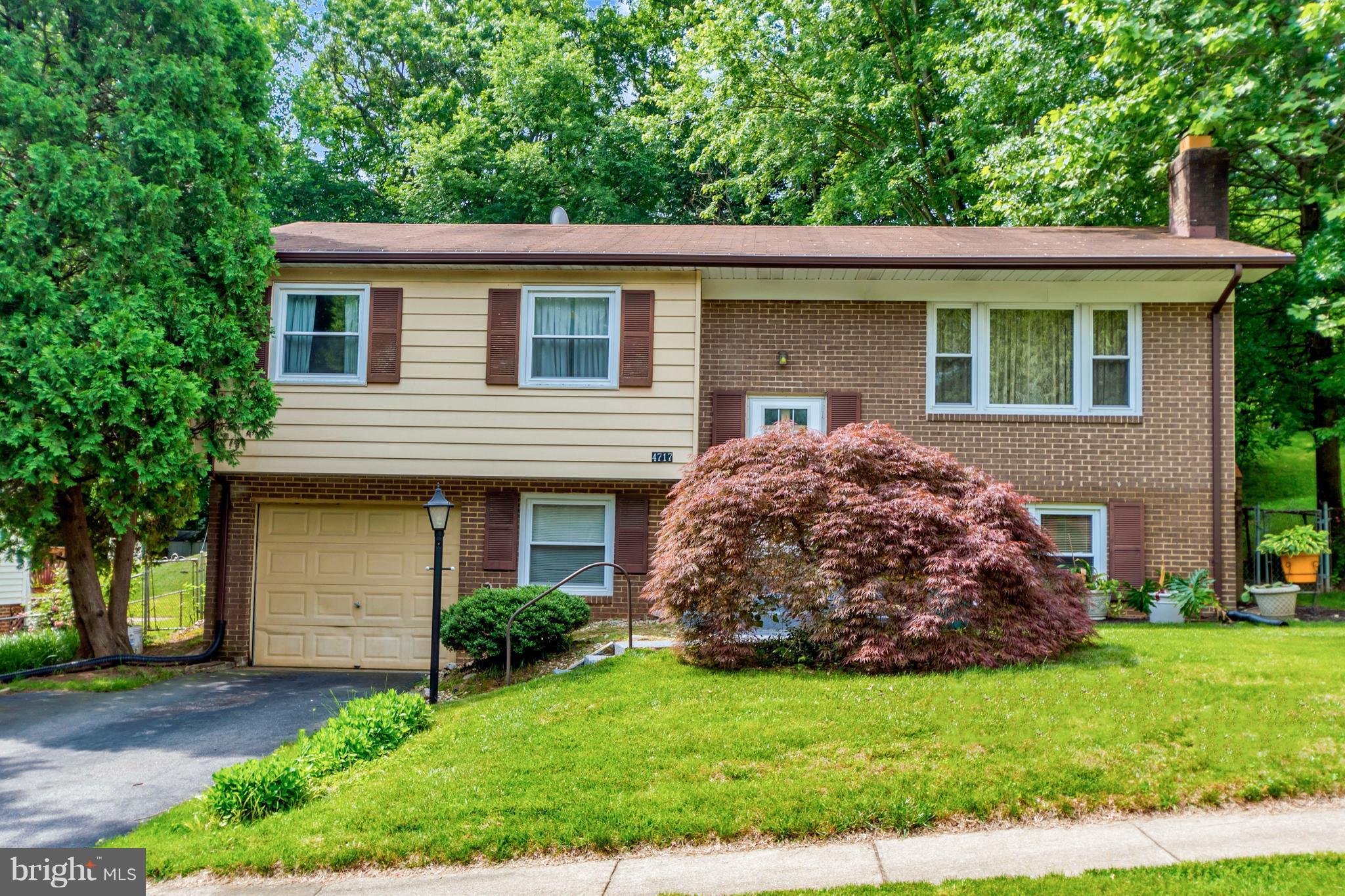 4717 Kilbane Road Woodbridge, VA 22193 - Photo 1 of 29 a front view of a house with a garden