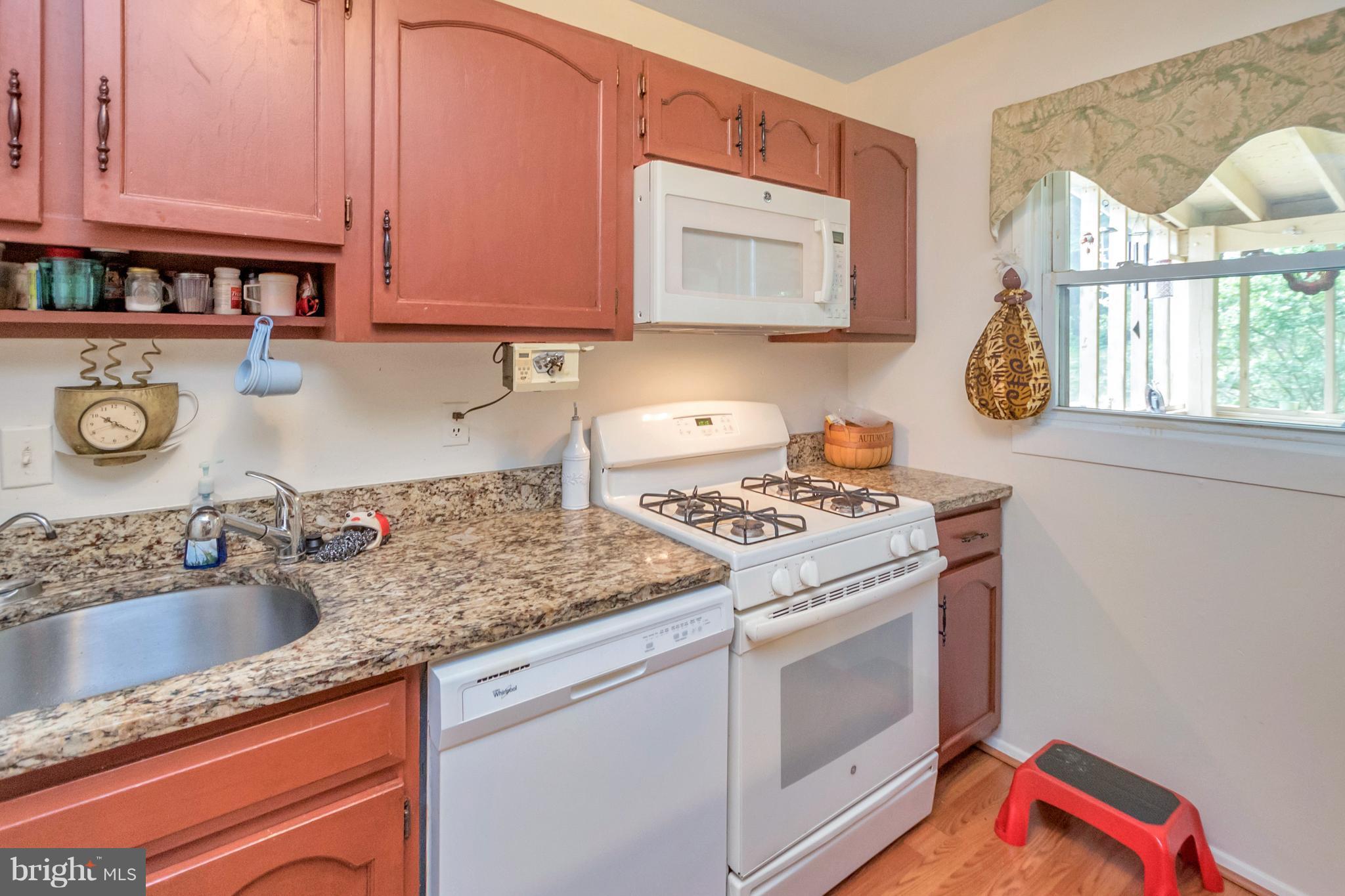 4717 Kilbane Road Woodbridge, VA 22193 - Photo 11 of 29 a kitchen with stainless steel appliances granite countertop a sink stove and cabinets