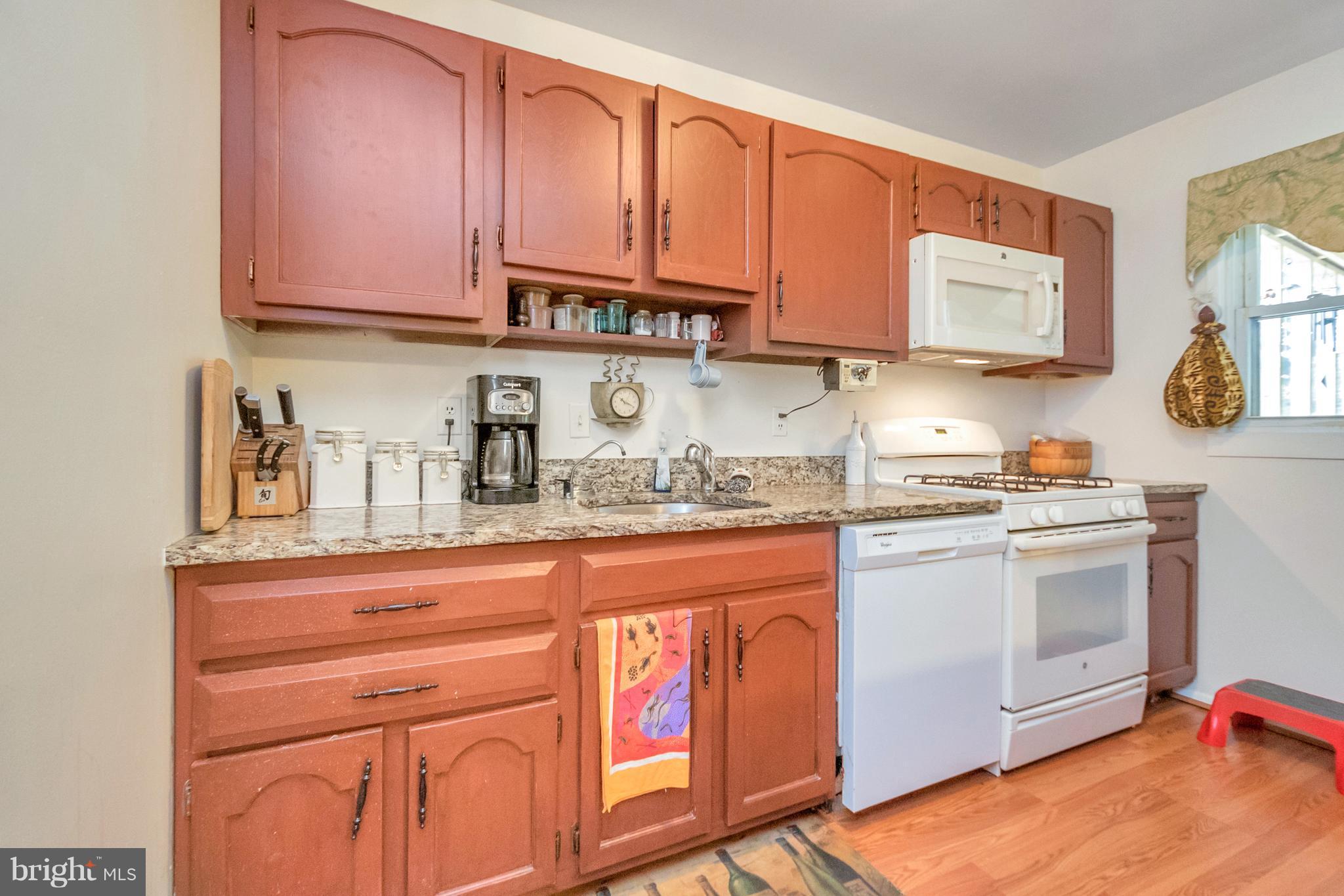 4717 Kilbane Road Woodbridge, VA 22193 - Photo 12 of 29 a kitchen with stainless steel appliances granite countertop a stove and a microwave with cabinets