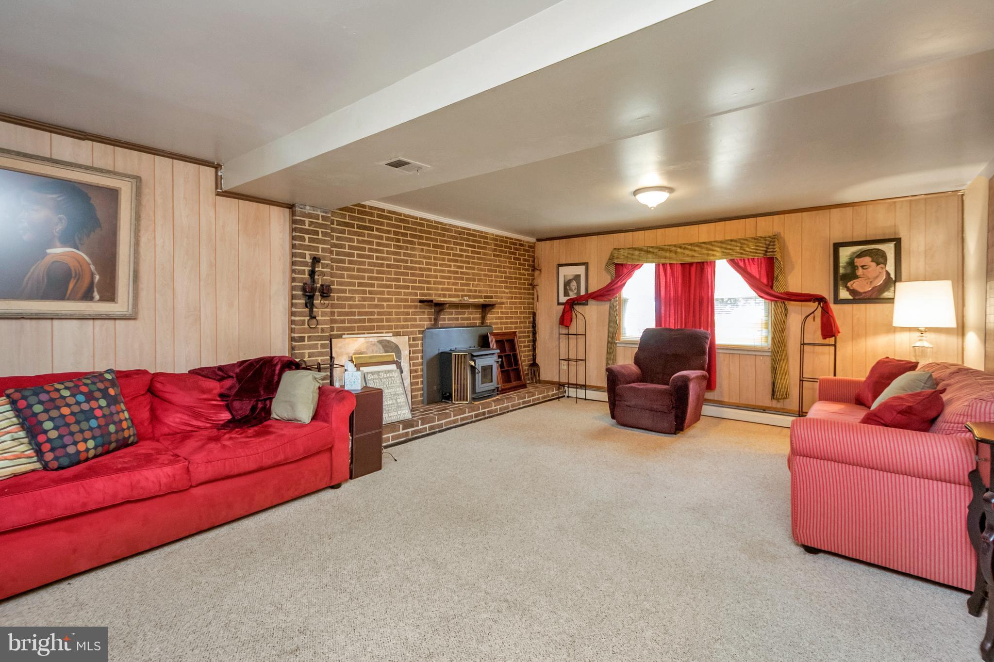 4717 Kilbane Road Woodbridge, VA 22193 - Photo 21 of 29 a living room with furniture a fireplace and a large window
