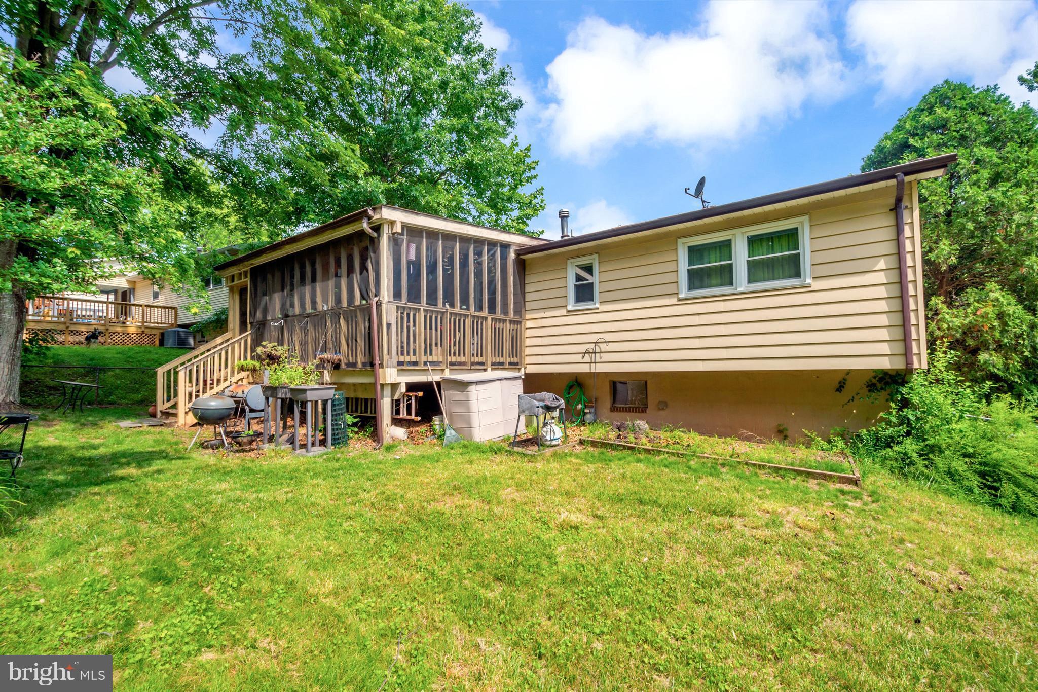 4717 Kilbane Road Woodbridge, VA 22193 - Photo 26 of 29 a yellow house with trees in front of it