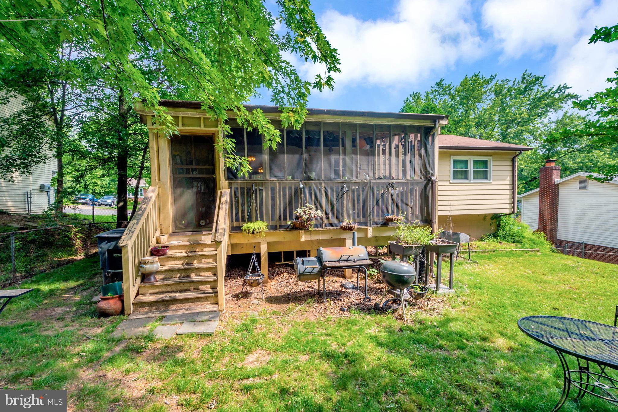 4717 Kilbane Road Woodbridge, VA 22193 - Photo 27 of 29 a view of backyard with table and chairs and potted plants