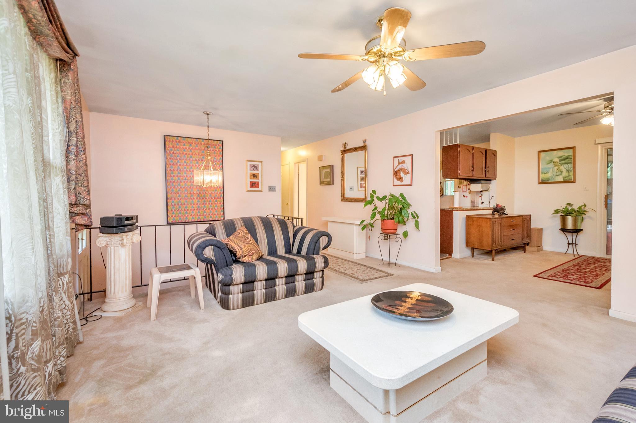 4717 Kilbane Road Woodbridge, VA 22193 - Photo 7 of 29 a living room with furniture and a dining table with wooden floor