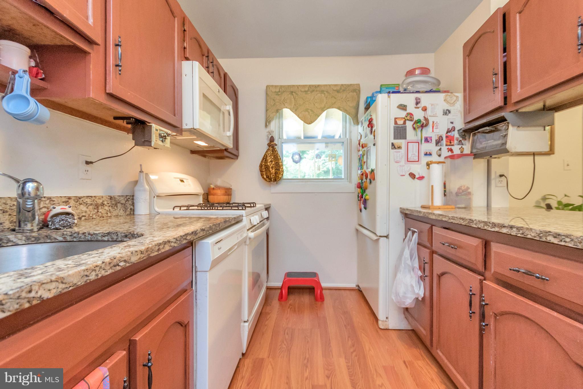 4717 Kilbane Road Woodbridge, VA 22193 - Photo 10 of 29 a kitchen with stainless steel appliances granite countertop a sink dishwasher stove and refrigerator with wooden floor