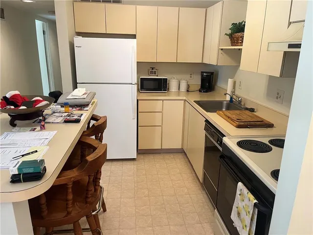 a kitchen with a stove a sink and a refrigerator