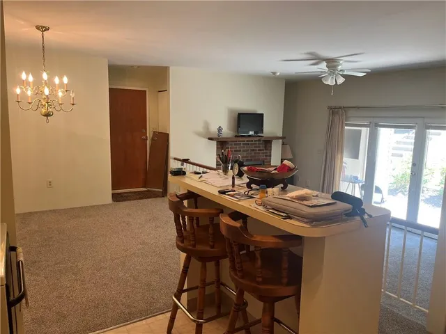 a view of a dining room with furniture and a chandelier