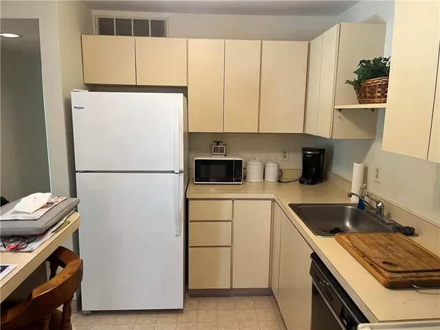 a kitchen with a refrigerator and a sink