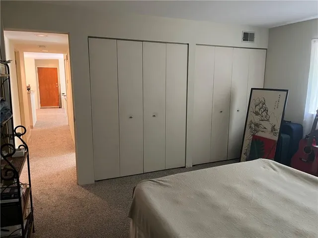 a bedroom with a bed and a dresser