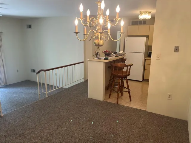 a view of entryway and hall with a mirror