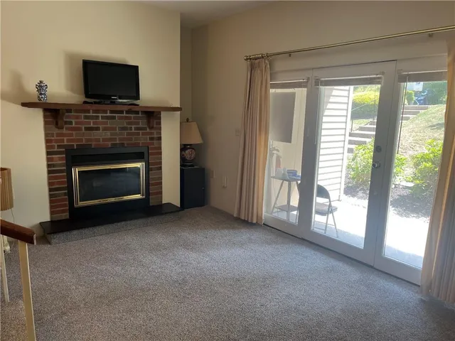a view of empty room with a fireplace