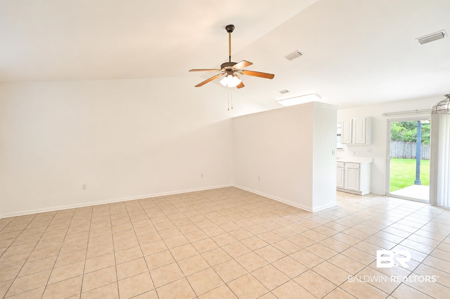 614 East Gate Circle Foley, AL 36535 - Photo 7 of 31 Spacious interior room featuring light-toned tile flooring, a vaulted ceiling, and a ceiling fan