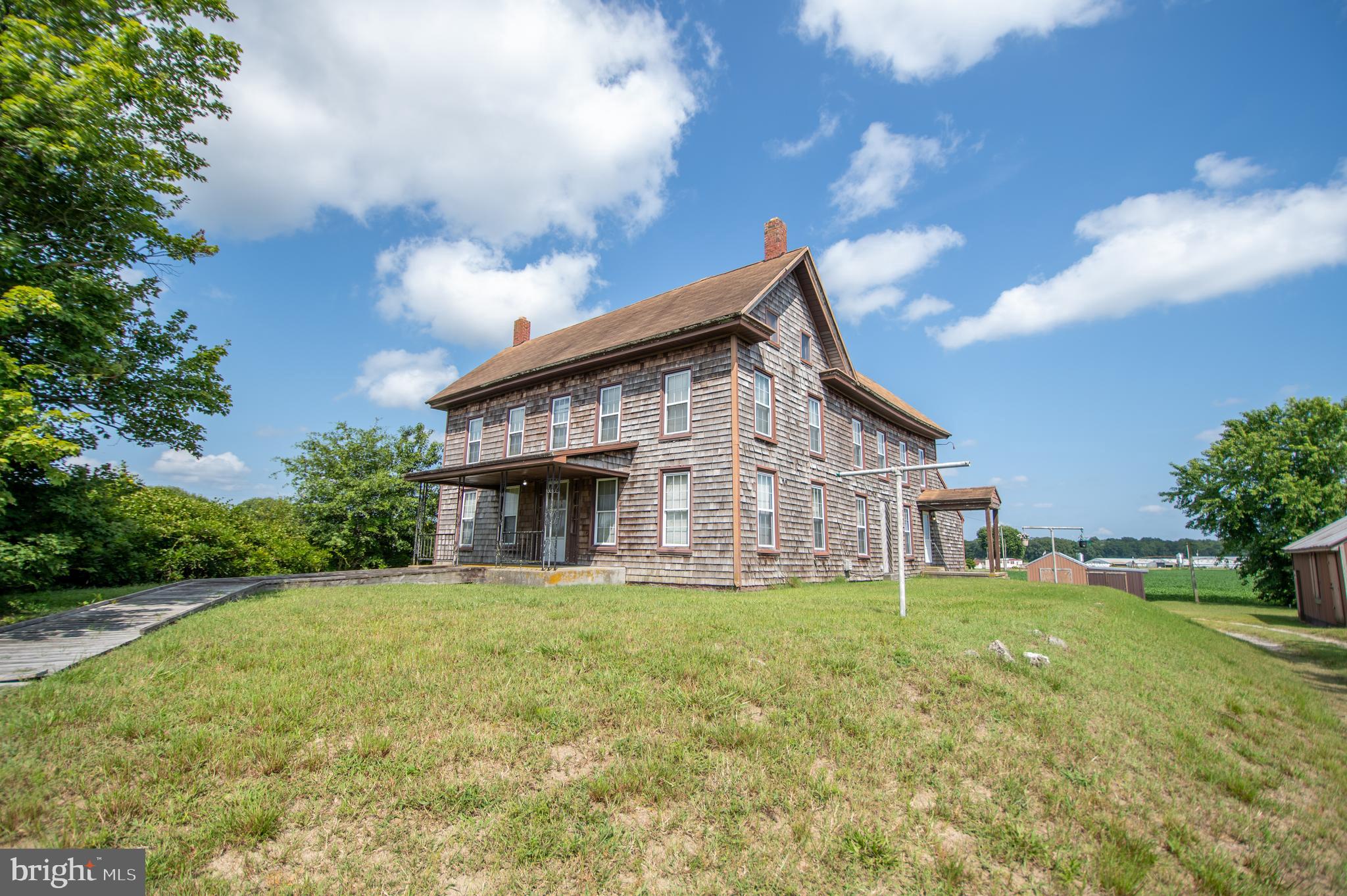 a view of a house with a yard and sitting area