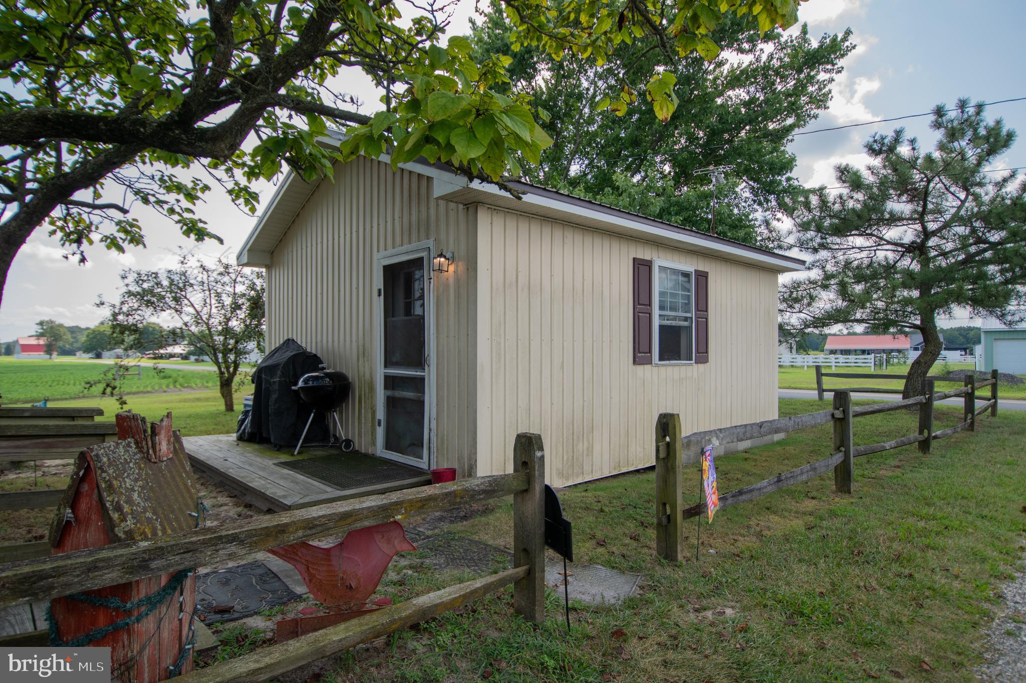 37245 Firemans Road Millsboro, DE 19966 - Photo 19 of 31 a backyard of a house with table and chairs