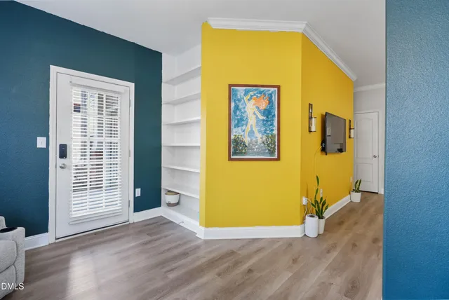 a view of a room with wooden floor windows and a kitchen