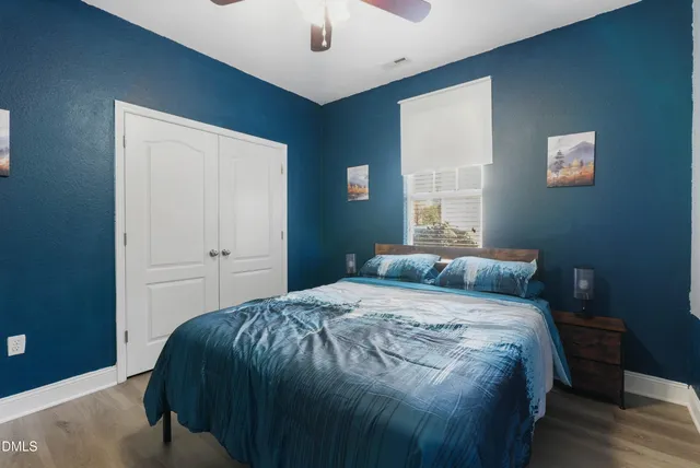 a bedroom with a bed and a window