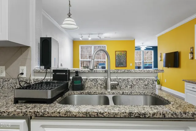 a kitchen with sink and a granite counter top