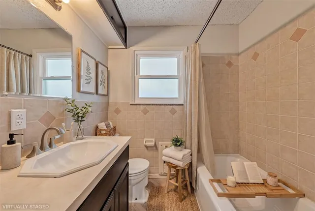 a bathroom with a sink a toilet and tub