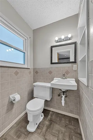 a bathroom with a sink toilet a mirror and bathtub