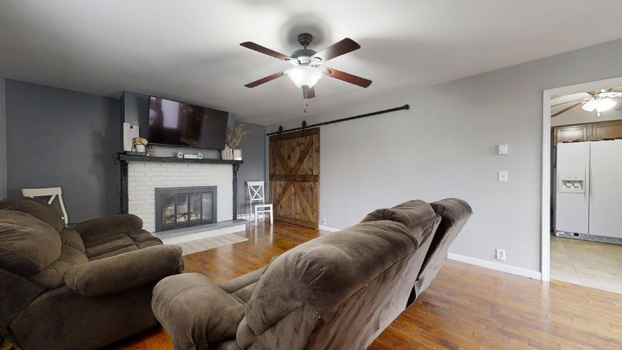 405 Park Circle St. Joseph, IL 61873 - Photo 12 of 35 a living room with furniture a flat screen tv and a fireplace