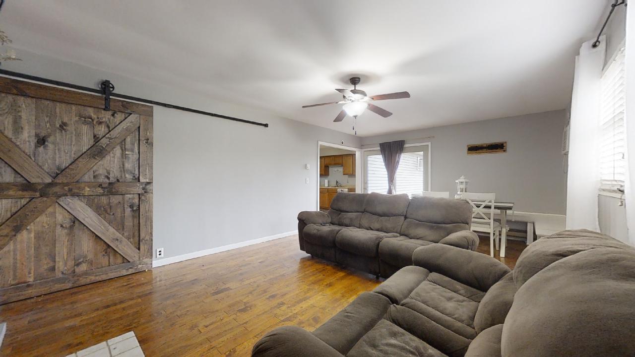 405 Park Circle St. Joseph, IL 61873 - Photo 15 of 35 a living room with furniture and a chandelier