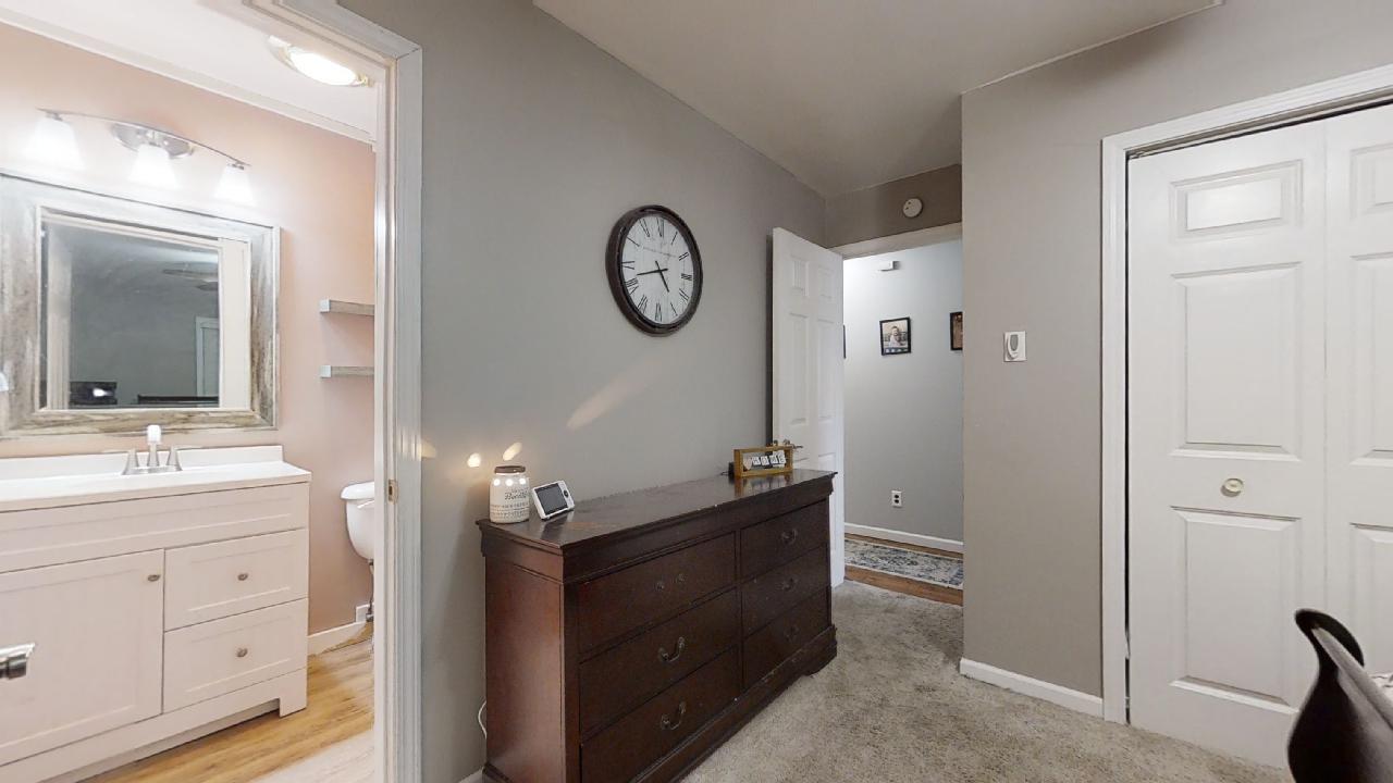 405 Park Circle St. Joseph, IL 61873 - Photo 21 of 35 a room with a mirror and a sink