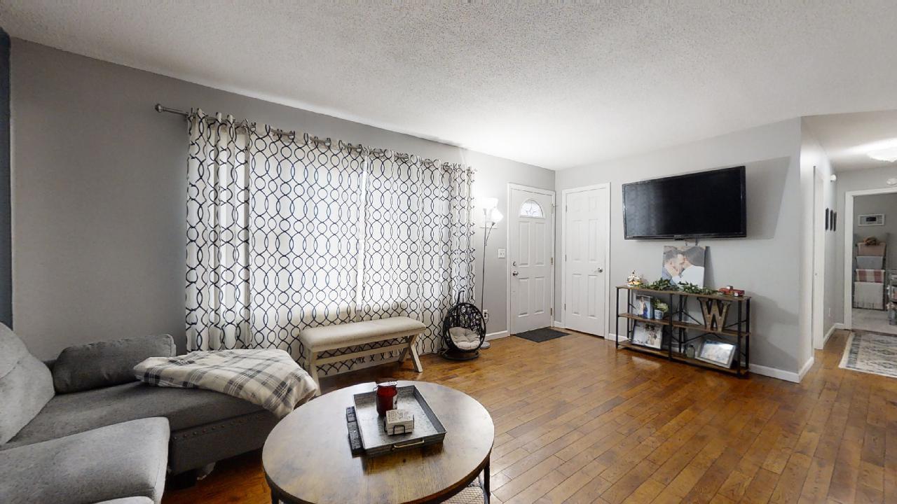 405 Park Circle St. Joseph, IL 61873 - Photo 6 of 35 a living room with furniture and a flat screen tv