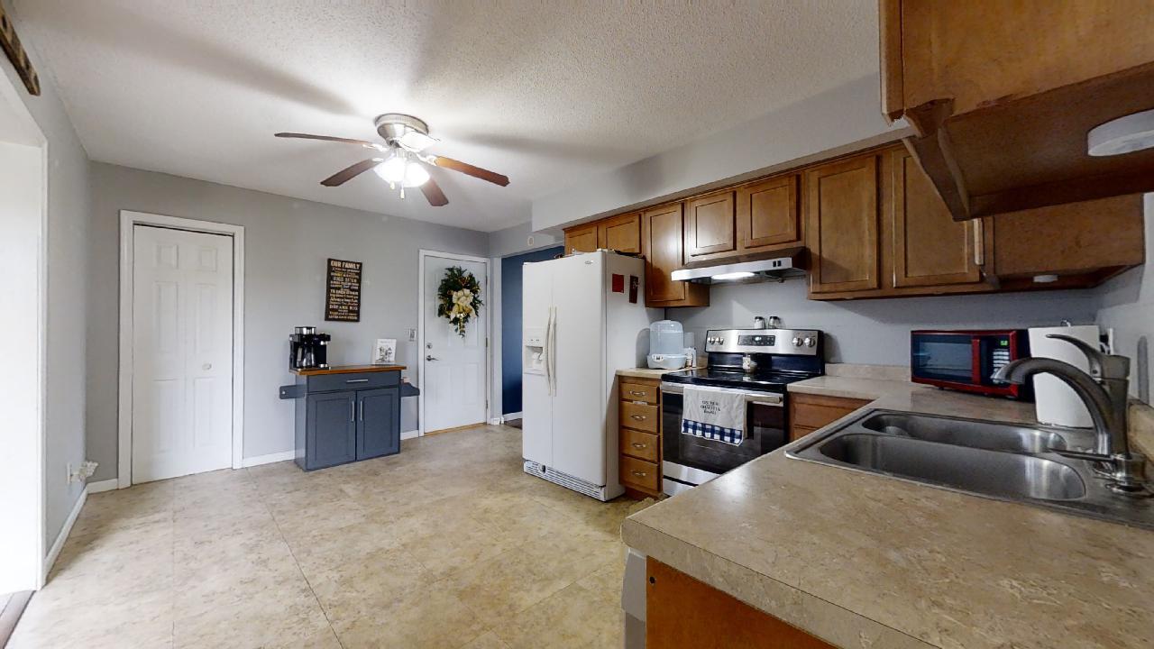 405 Park Circle St. Joseph, IL 61873 - Photo 9 of 35 a kitchen with stainless steel appliances granite countertop a sink stove and refrigerator