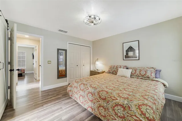 a bedroom with a large bed and a chandelier