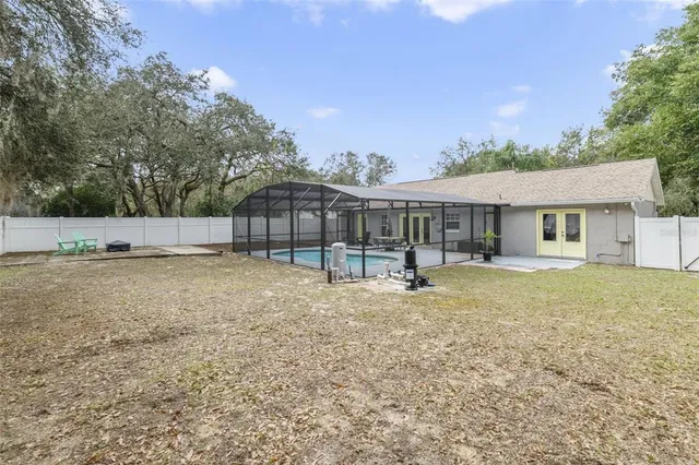 a backyard of a house with table and chairs