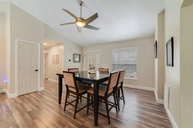 a view of a dining room with furniture and wooden floor