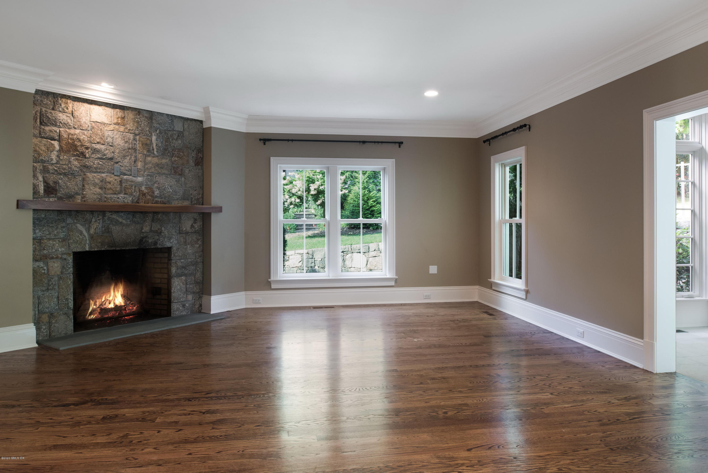 53 Hillside Road Greenwich, CT 06830 - Photo 14 of 31 a view of an empty room with wooden floor fireplace and a window