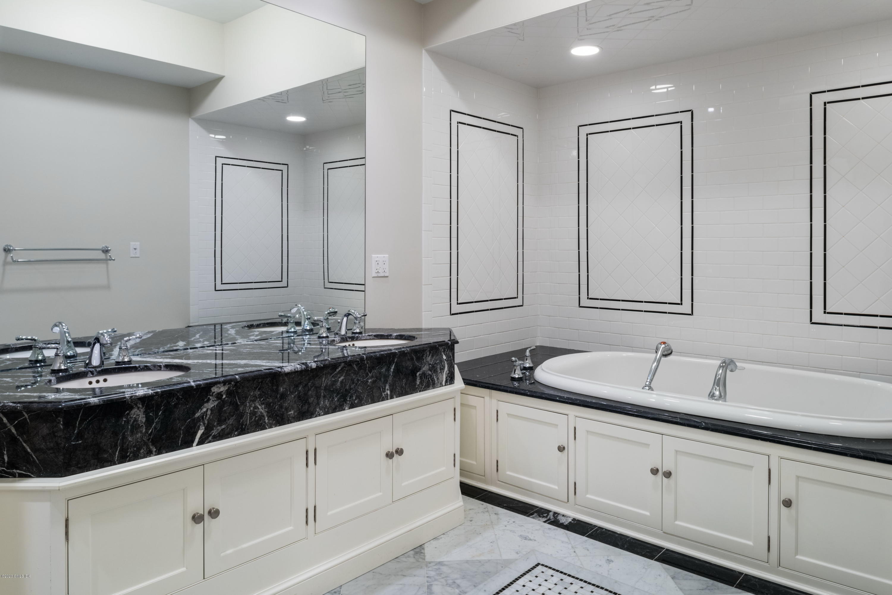 53 Hillside Road Greenwich, CT 06830 - Photo 18 of 31 a bathroom with double sink and a mirror