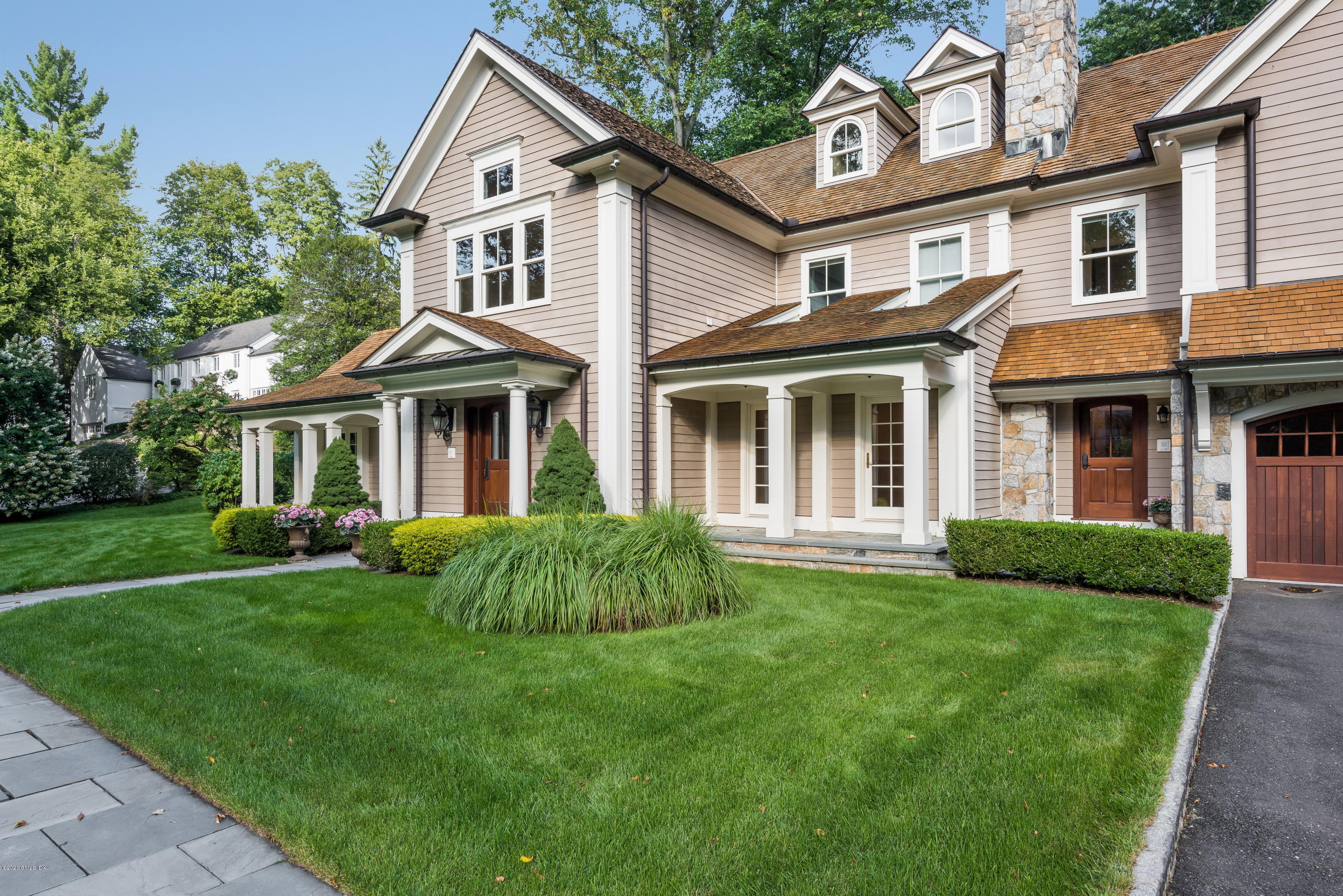 53 Hillside Road Greenwich, CT 06830 - Photo 2 of 31 a front view of a house with a garden